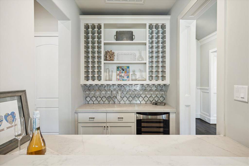 This pretty Butler's Pantry/Bar (6' x 7'10") is located right off the kitchen and offers beautiful storage, and a wine chiller. Great for entertainng.