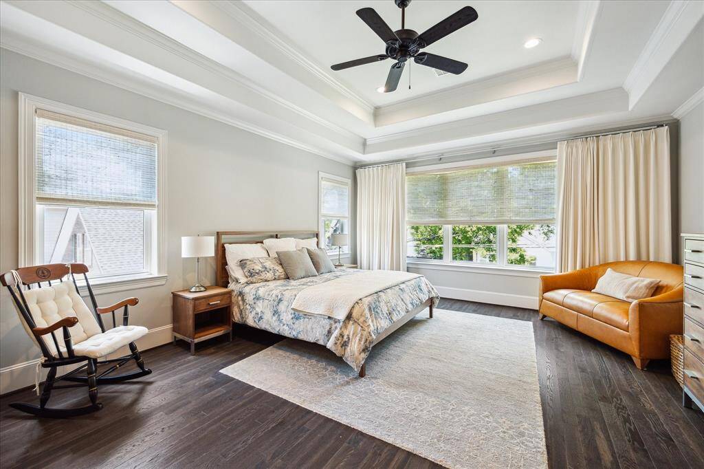 Enjoy a true retreat...this Primary Bedroom (26' x 20') features a coffered ceiling, two closets & a spa bath. The sellers added custom blinds and draperies to complete this room.