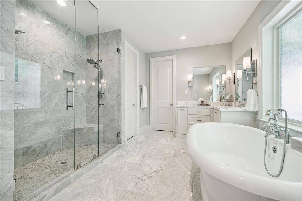 This Primary Bath is pretty as a picture and offers elegant features including quartz vanities, stand-alone bathtub, and oversized, seamless shower.