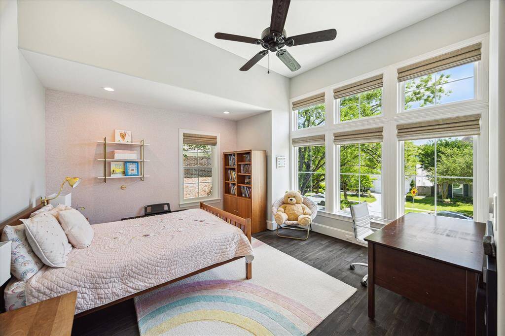 There are three Secondary Bedrooms. This bedroom (15' x 13') features beautiful wood flooring, a lovely wall of windows and a walk-in closet.
