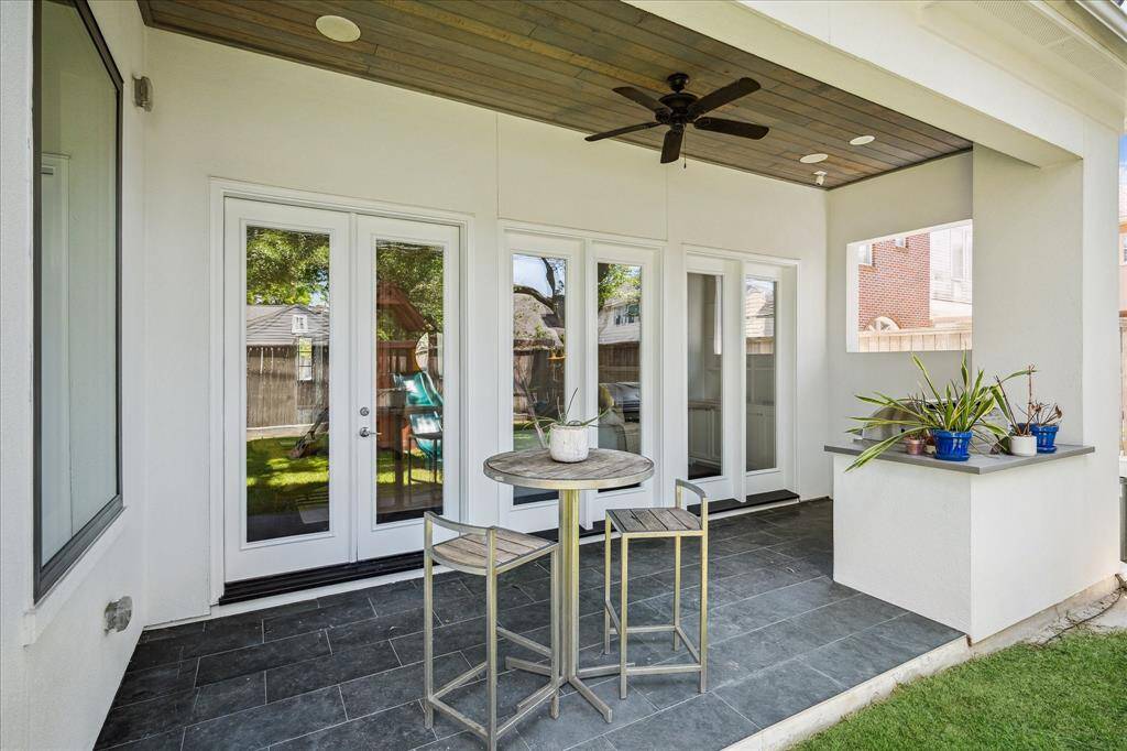Step onto this covered patio overlooking a wonderful greenspace & backyard.