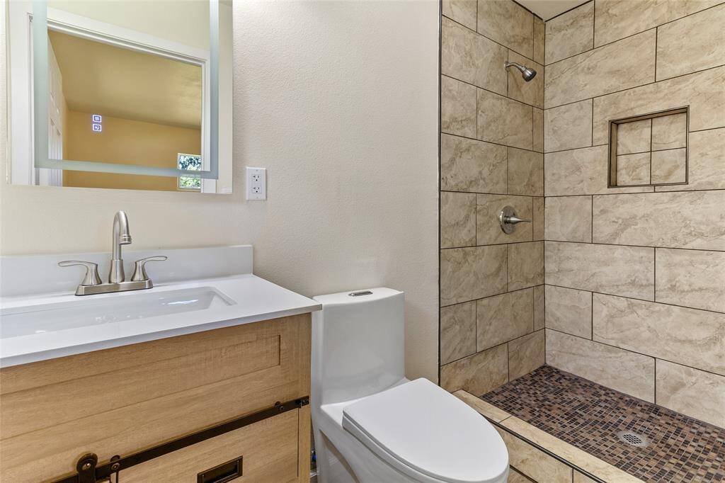 Fully updated primary bathroom with lighted and heated mirror