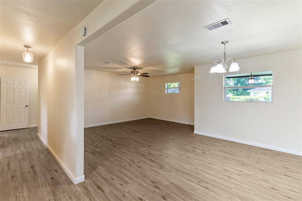 Living room, dining area, and hallway. New windows throughout the home.