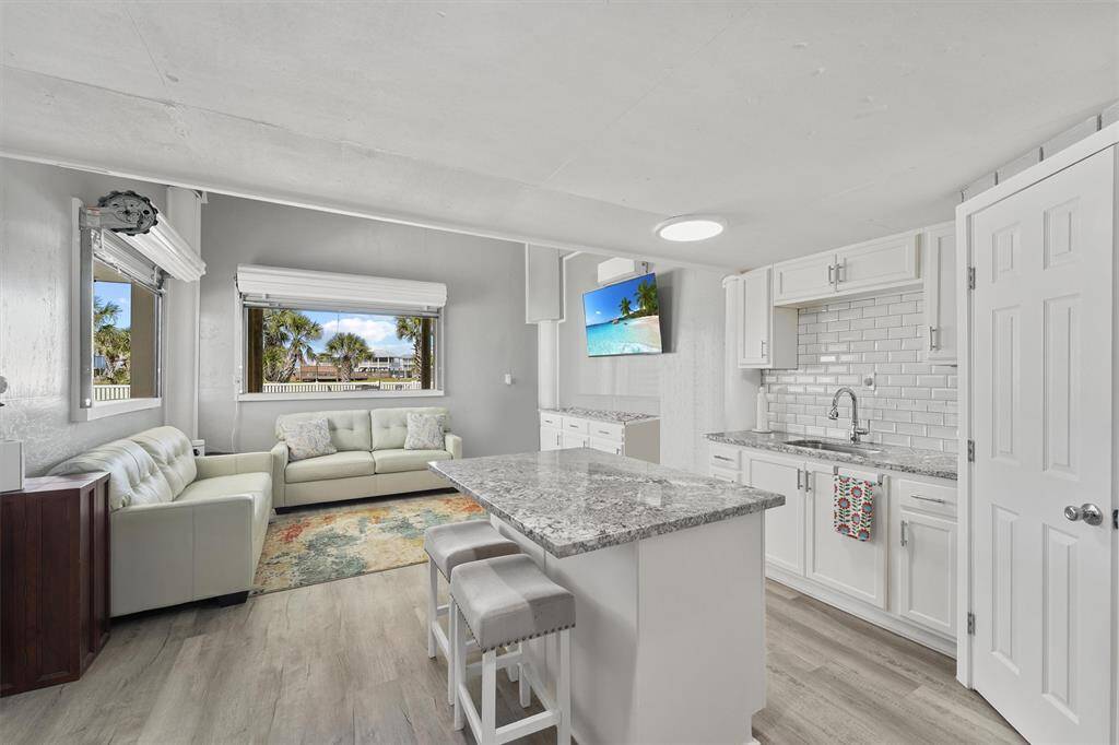 Versatile downstairs bonus room with abundant natural light, custom built-ins, and serene views