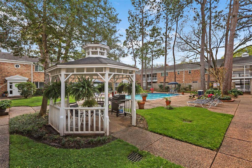 Enjoy serene views of the lush courtyard and inviting pool from your living room window. This is literally your view!