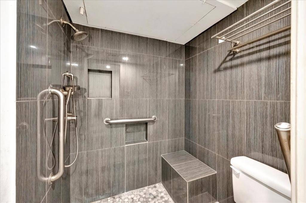 Oversized tiled shower with seating is luxurious and practical