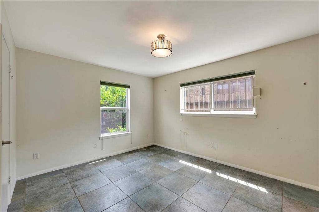 On the left is an expansive walk-in closet with built-in shelving and room to spare