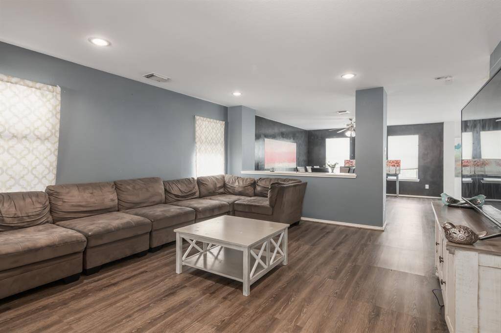 Spacious Living Room and Dining seamlessly blend creating a welcoming atmosphere.