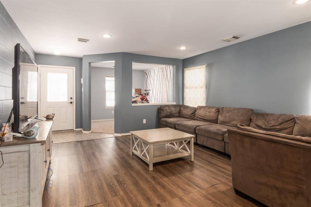 Spacious living room with natural light coming from living and office area