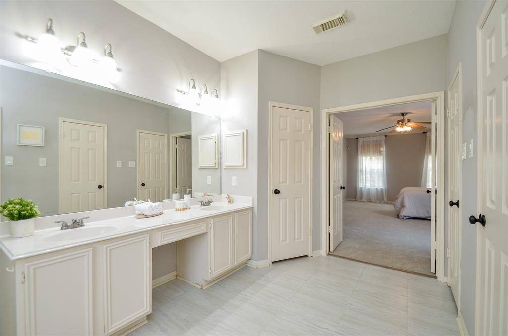 PRIMARY ENSUITE HAS A LARGE LINENS CLOSET AND 2 WALK-IN CLOSETS