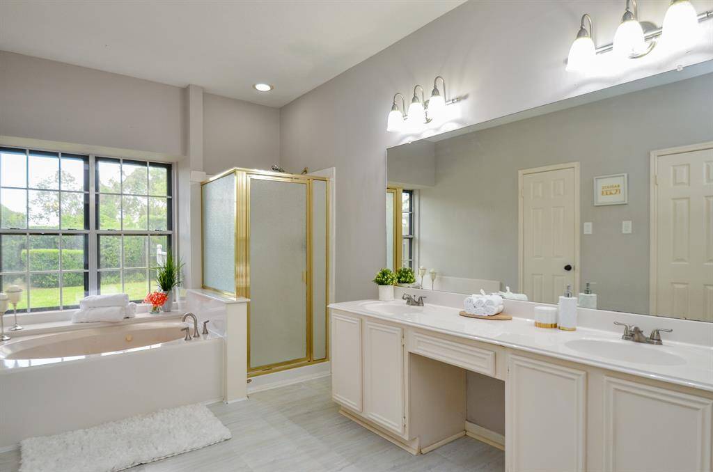 PRIMARY BATHROOM HAS A WINDOW WITH GORGEOUS VIEW TO THE BACKYARD