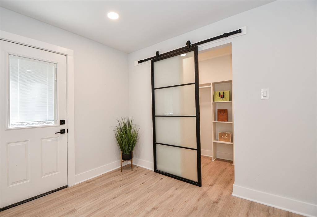 Spacious Primary closet with modern barn door.