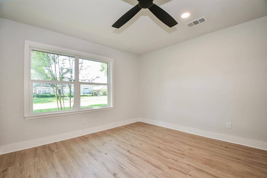 Guest Bedroom with high baseboards and new Luxury flooring