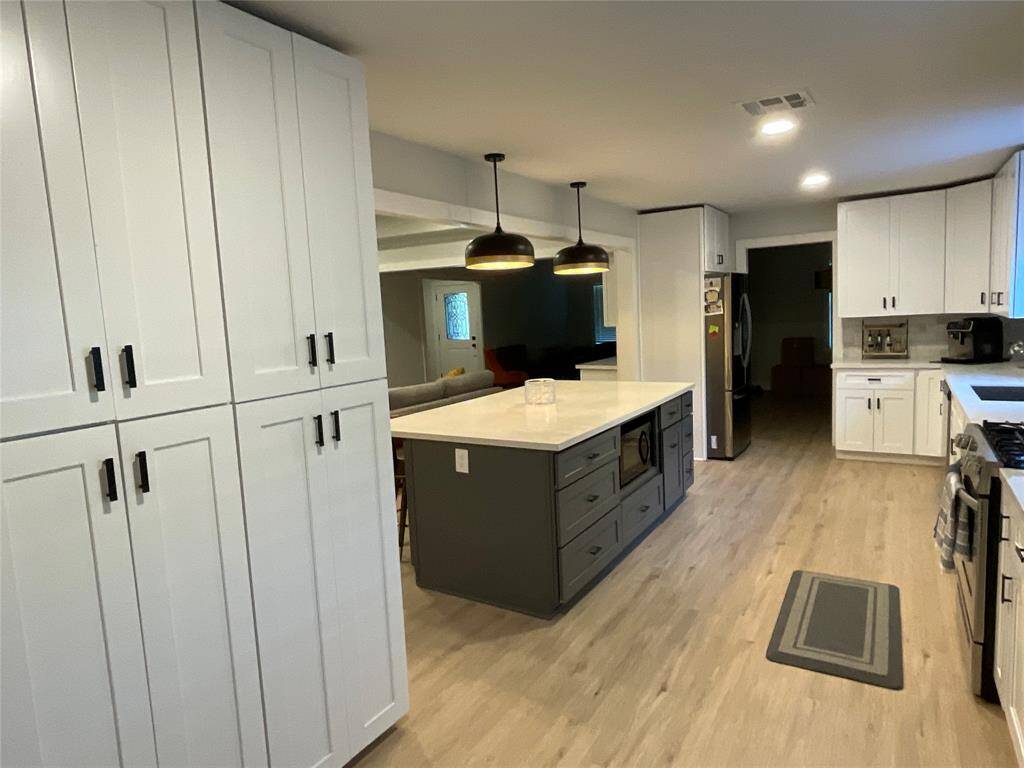Updated kitchen with tons of pantry storage and island with microwave.