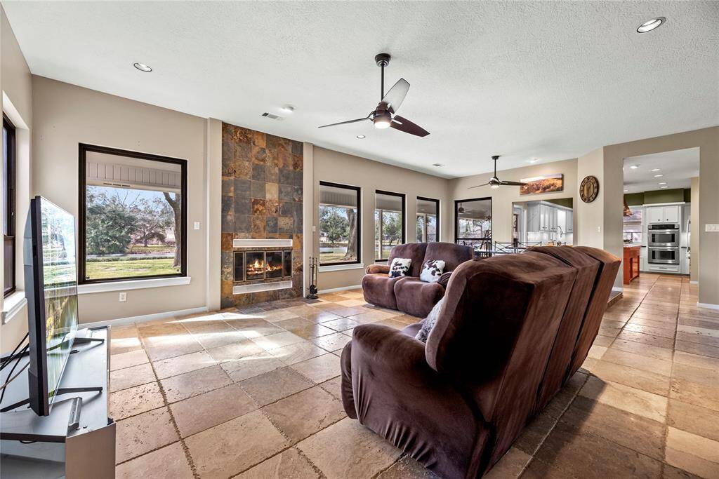 Welcoming and conveying warmth, the living room offers an inviting space for evening movies or holiday gatherings. Tune into your favorite streaming show, while admiring the cozy fireplace.