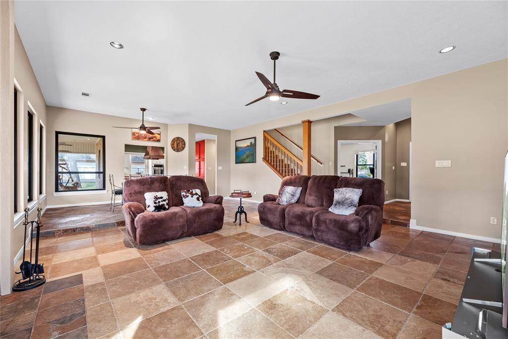 The connected and wide-open living room and dining room offer interesting entertaining possibilities. Utilize the spaces in a traditional manner or have a custom-made farmhouse table to sprawl across both rooms, fitting all your family, cousins, and friends!