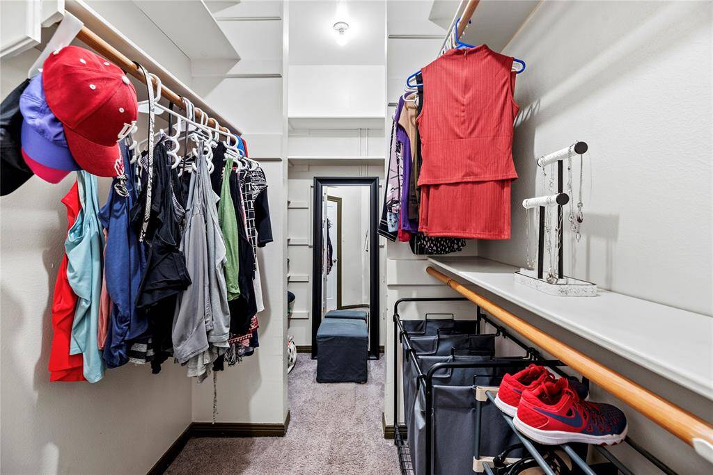 No matter how often you purchase new threads online or at the mall, this walk-in pimary bedroom closet has space for all your new and favorite wares! High ceilings also afford the possibility of additional shelving or easy stacking.