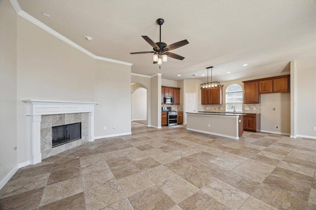 Open floor plan with fire place and crown molding with 18 inch tile flooring!!!