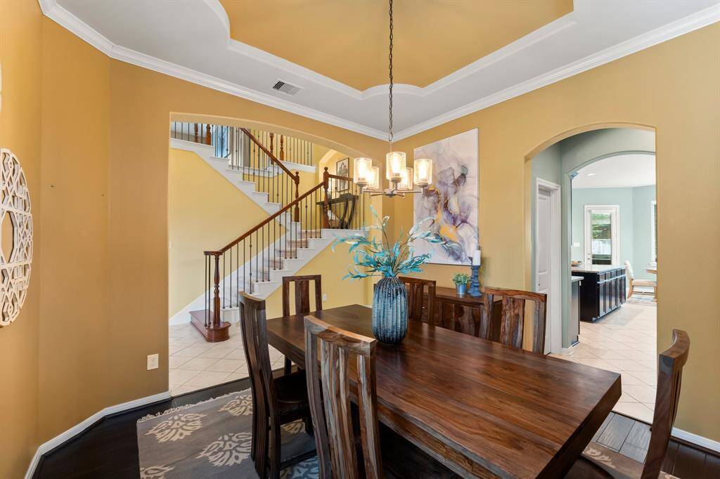 This beautiful dining room opens to the main entry, offering a graceful flow toward the staircase and family room, with a secondary entry providing easy access to the kitchen.