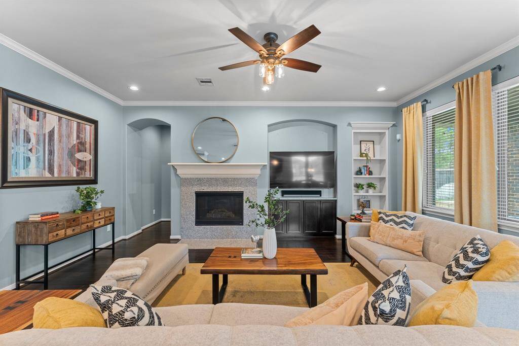 This spacious family room is perfect for entertaining guests or simply unwinding by a cozy fire.