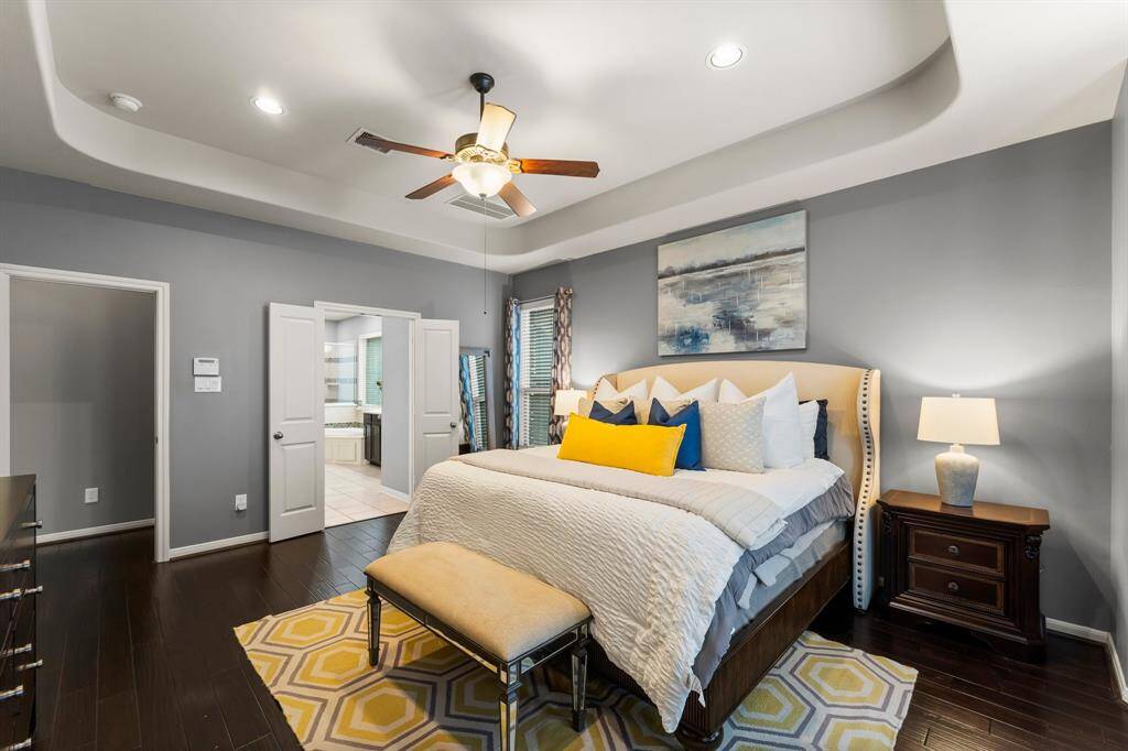 The primary bedroom boasts double doors that open to an oversized ensuite bathroom, adding a touch of luxury and privacy.