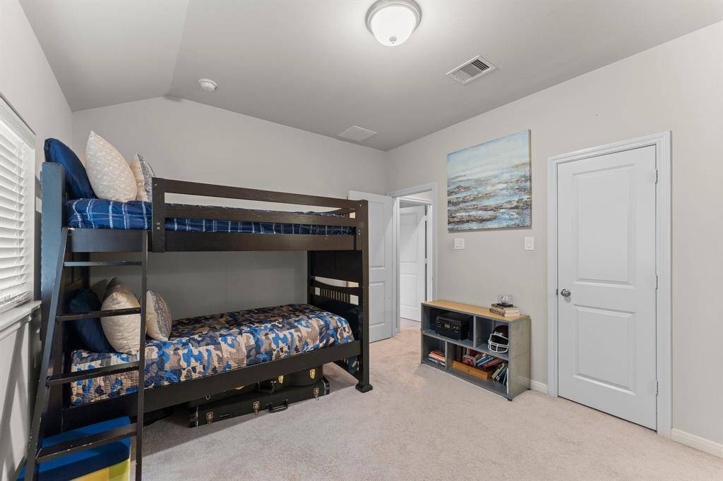 The secondary bedroom just off the Jack and Jill bathroom features vaulted ceilings, walk-in closet, and a large window that fills the room with natural light.