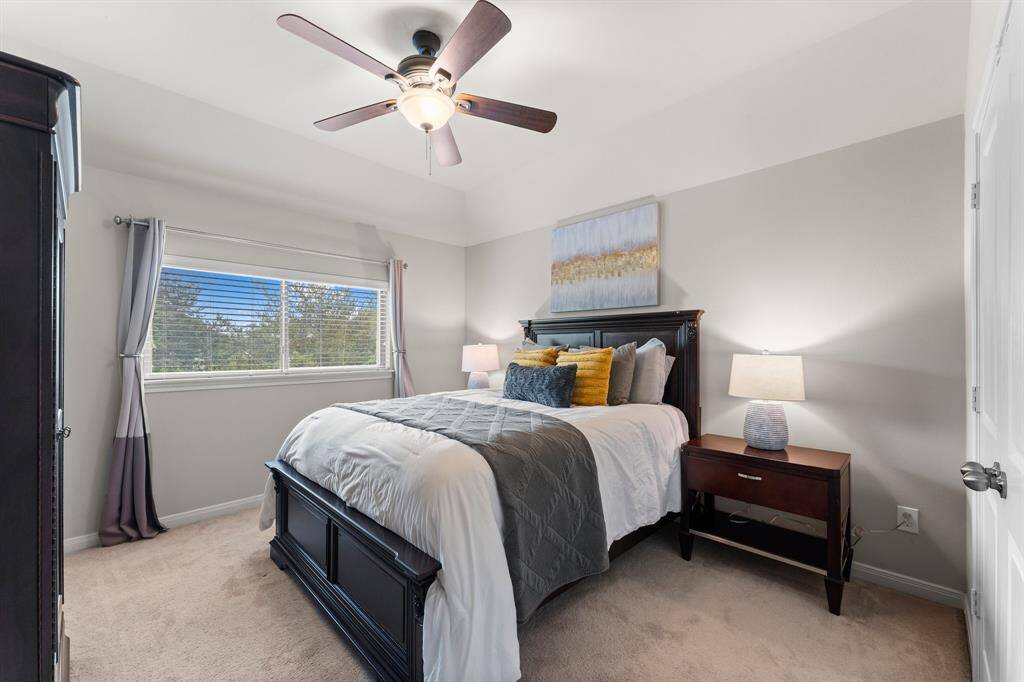 The third secondary bedroom, located just past the hall bathroom, is spacious and bright with vaulted ceilings.
