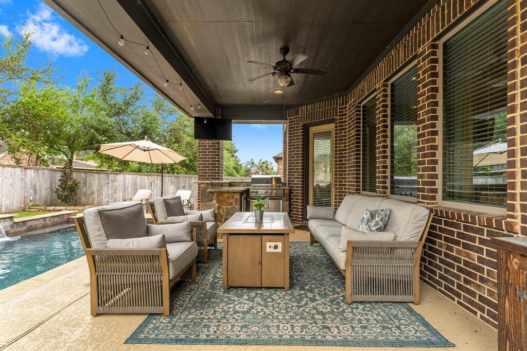 This expansive covered patio overlooks the stunning pool and features a fully equipped outdoor kitchen—perfect for grilling, entertaining, relaxing, or simply enjoying a good book.