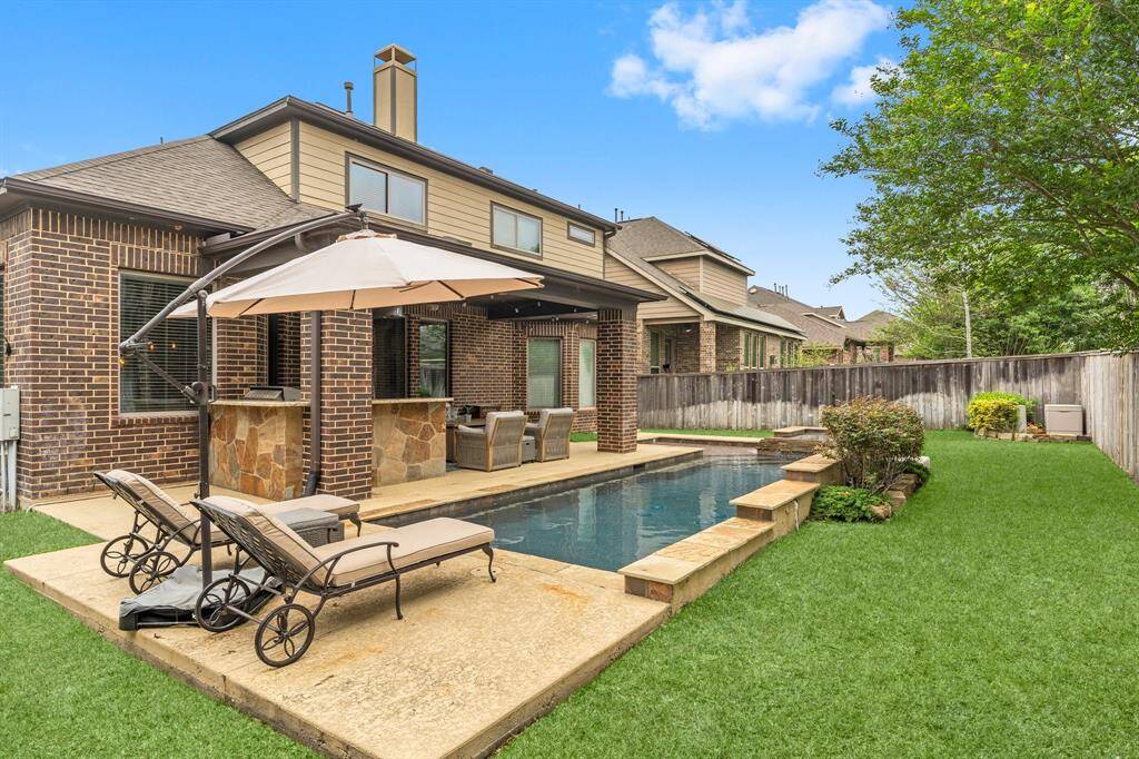 The backyard offers ample space for lounging poolside, making it the perfect spot to soak up the sun and unwind in style.