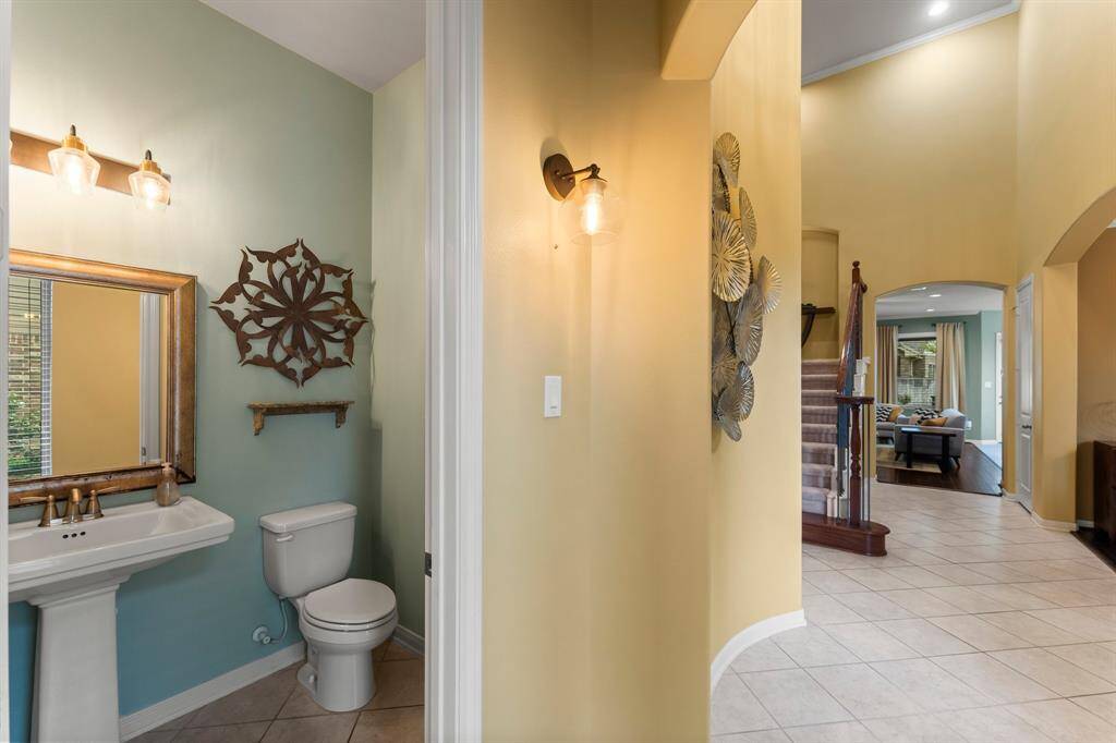 Conveniently located just off the entryway, the private powder room sits adjacent to the versatile home office or flex space