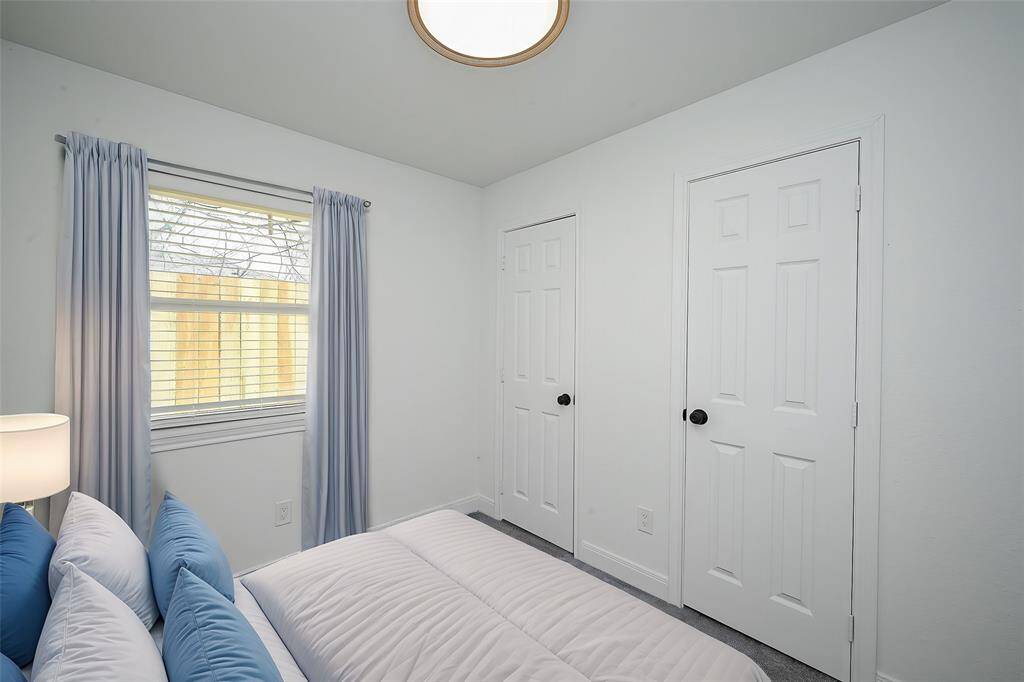 Virtually Staged: Secondary bedroom with carpet floors, and two built-in closets.