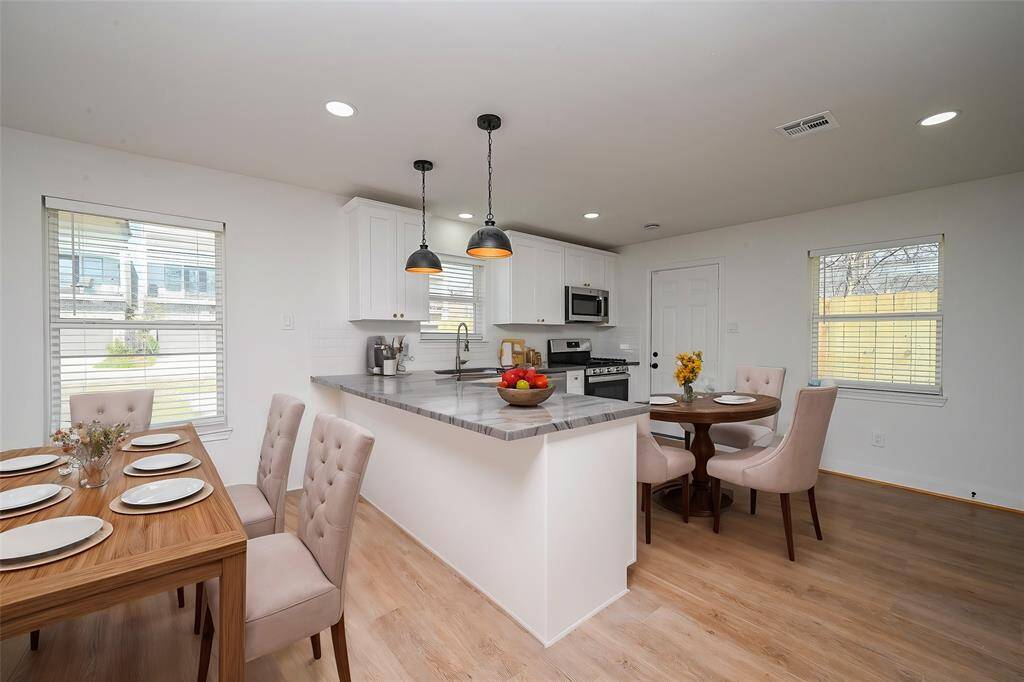 Virtually Staged: The dining area is seamessly connected with the kitchen, and includes a window with privacy blinds with views straight into your backyard.