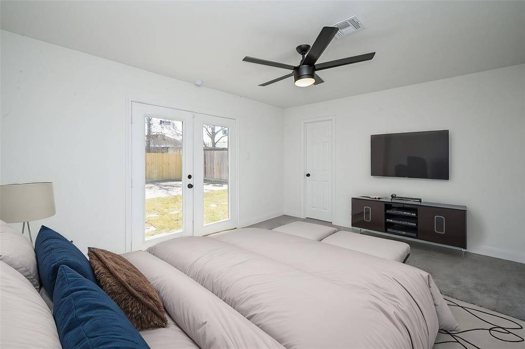 Virtually Staged: Primary bedroom with carpet floors, a walk-in closet, and with an ensuite bathroom. It also features double glass doors with immediate access to the backyard.