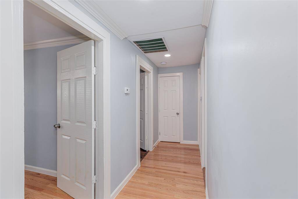 hallway to bedrooms 3 & 4 and full size bathroom and half bath at the end of the hallway
