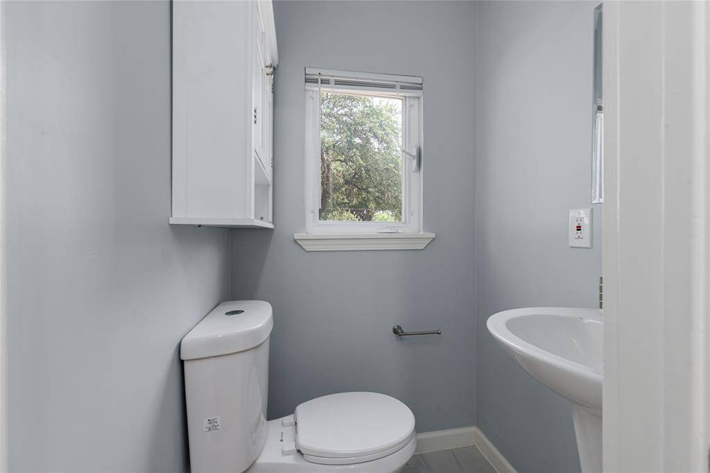 A convenient half-bath is located at the end of the hallway