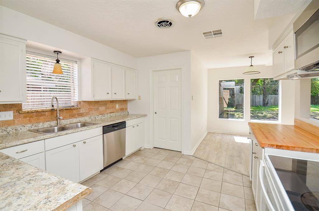 Kitchen looking towards the laundry room and breakfast area.