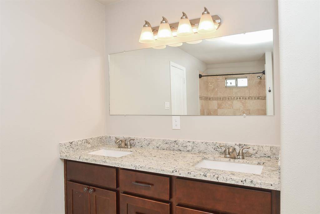 The primary bathroom offers a spacious retreat with double sinks, a large walk-in closet, and a built-in ceiling speaker — perfect for enjoying your favorite music while you get ready or wind down