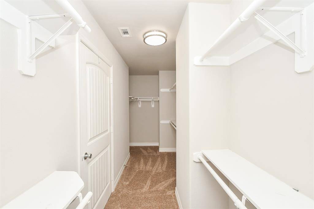 The primary bathroom offers a spacious retreat with double sinks, a large walk-in closet, and a built-in ceiling speaker — perfect for enjoying your favorite music while you get ready or wind down