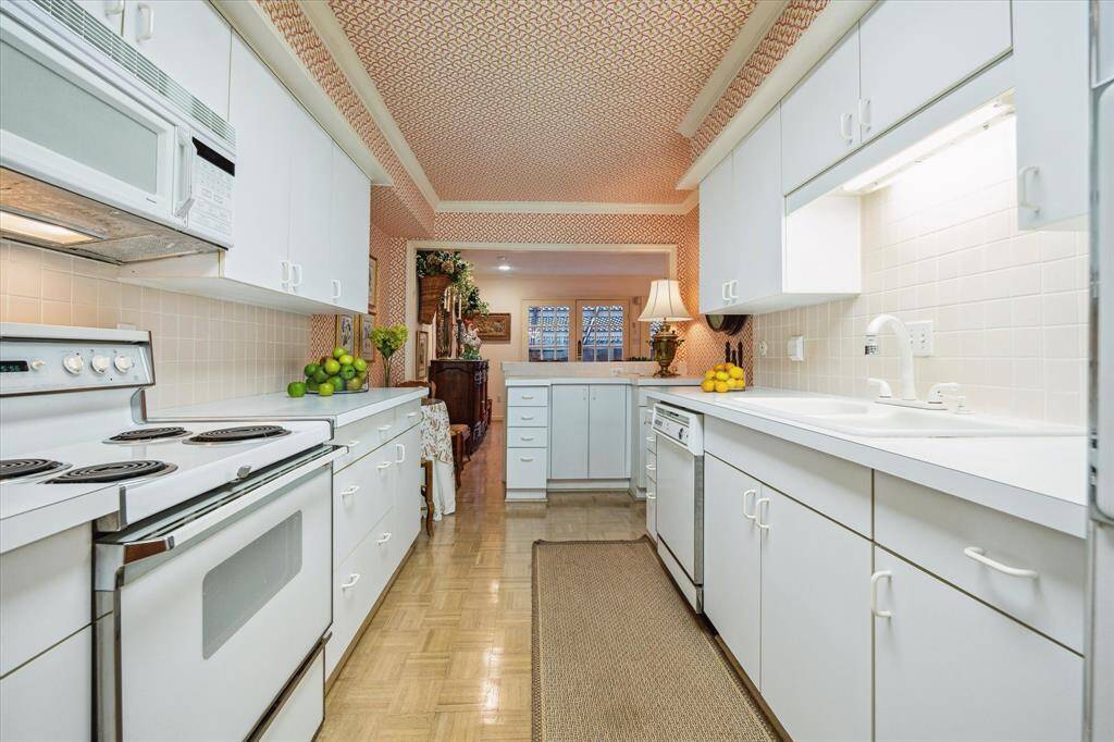 Kitchen is accessible from the dining room and den.