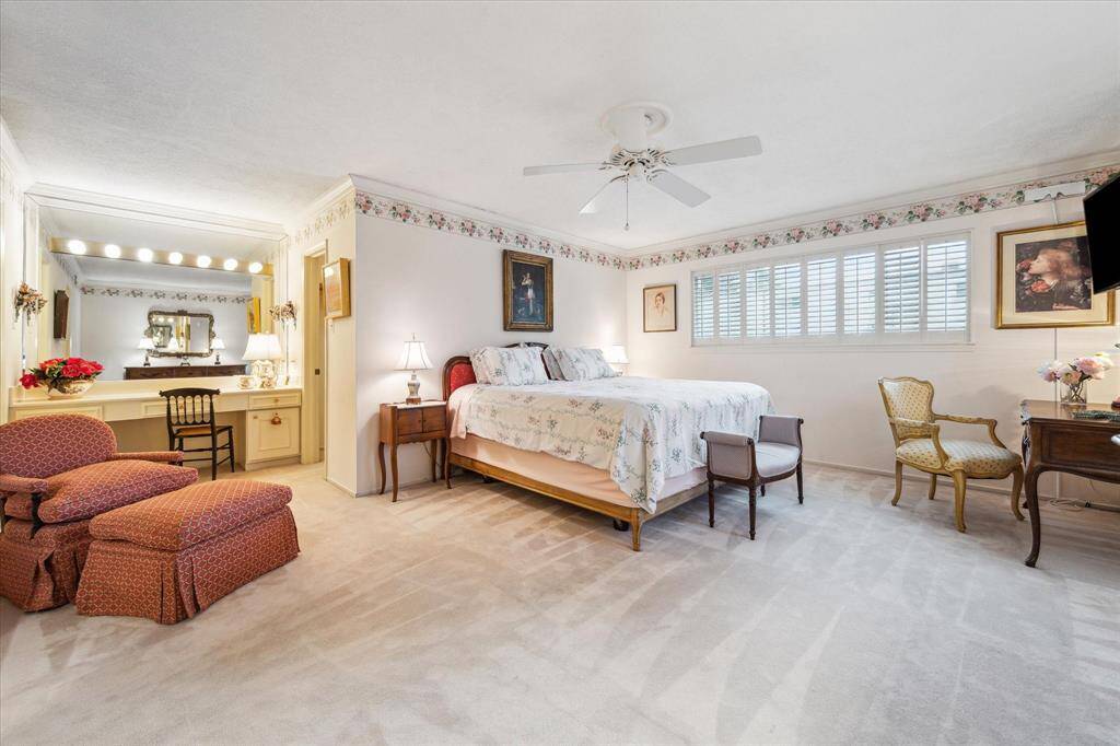 Upstairs is a huge primary bedroom with vanity area and walk-in closet.