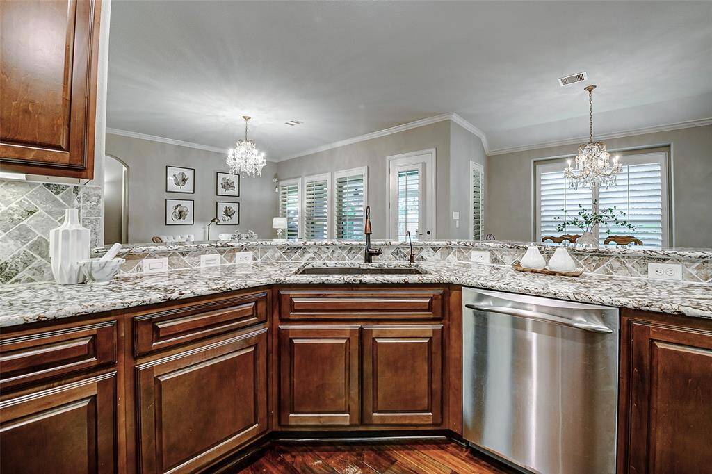 A spacious breakfast bar, perfect for casual meals or conversation, overlooks the kitchen, allowing the home chef to stay connected with guests while cooking.