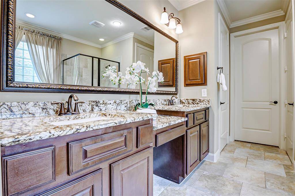 Step into the primary bathroom, where you’ll be greeted by a vanity featuring dual sinks, offering plenty of room for both functionality and style. A convenient sit-down area is perfect for preparing for the day or indulging in your beauty routine. The linen closet is a convenient place to store your towels.