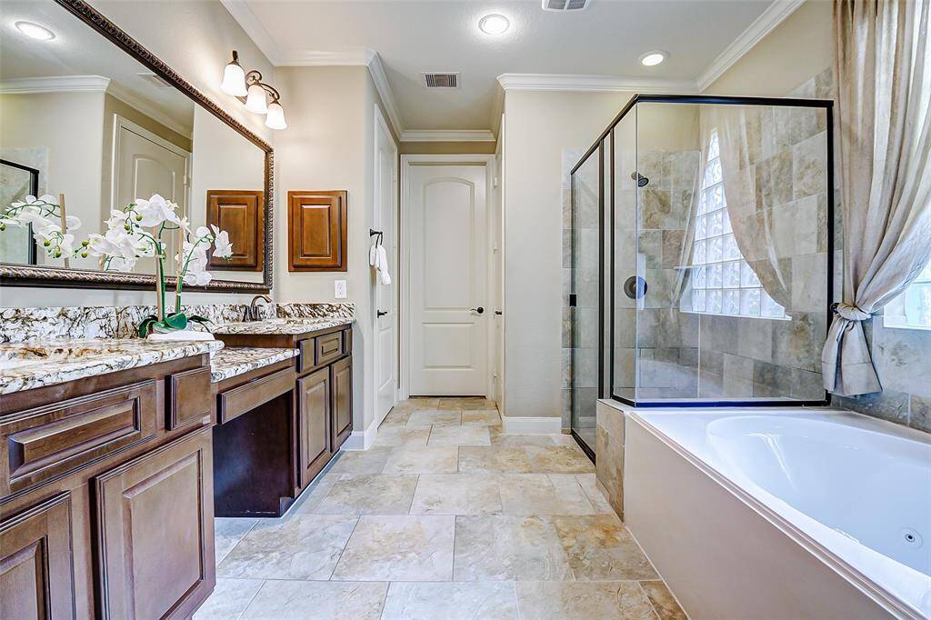 The walk-in shower offers the ultimate space for relaxation and rejuvenation. The modern fixtures enhance the sense of comfort, while sleek tile work adds elegance to the space.