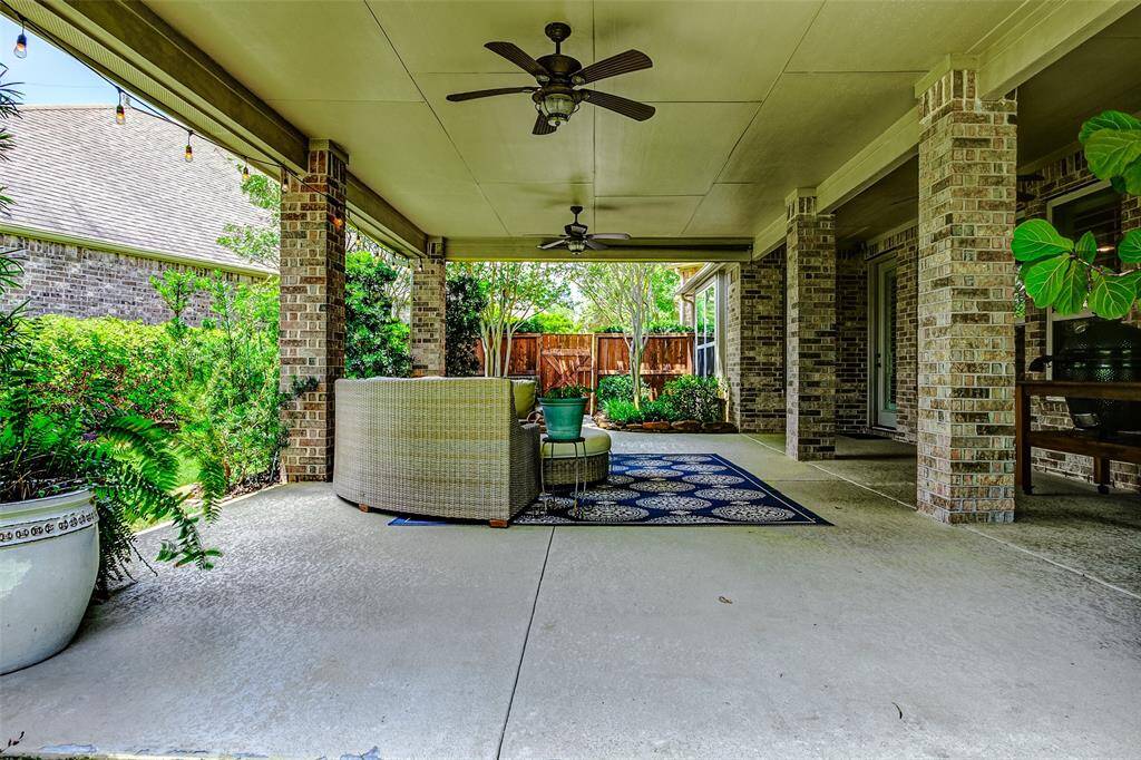 Enjoy peaceful evenings or lively gatherings on this oversized covered patio, which overlooks the backyard.