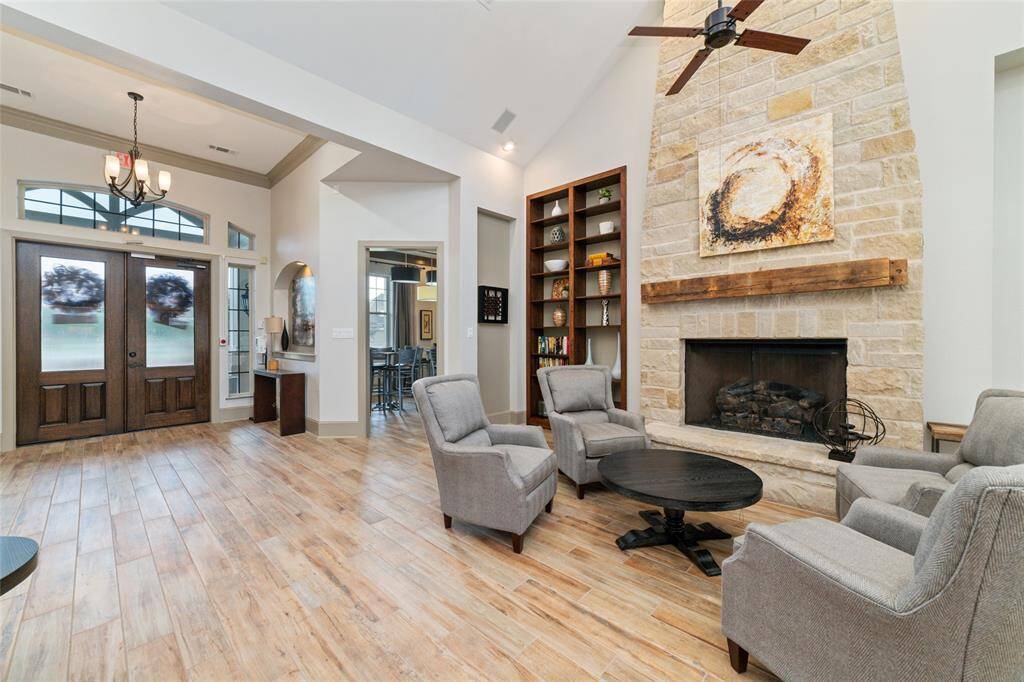 This inviting main visiting area of the clubhouse provides a beautiful stone fireplace and comfortable seating.