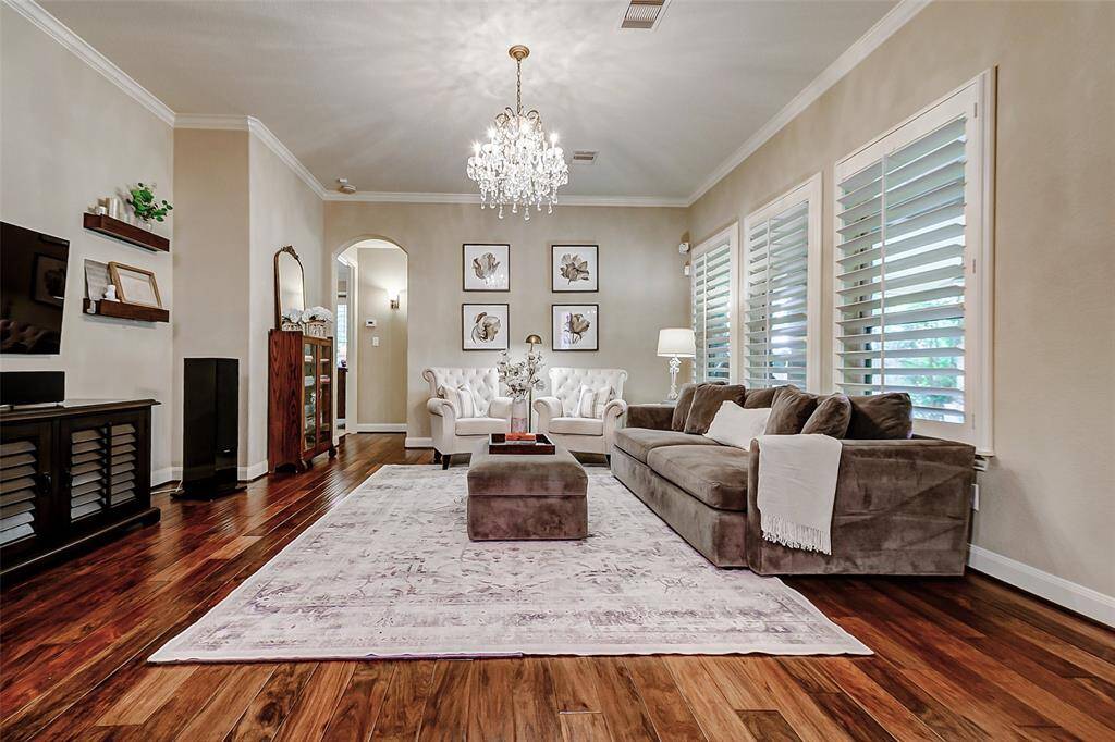 Large windows fitted with classic plantation shutters offer both privacy and timeless style.