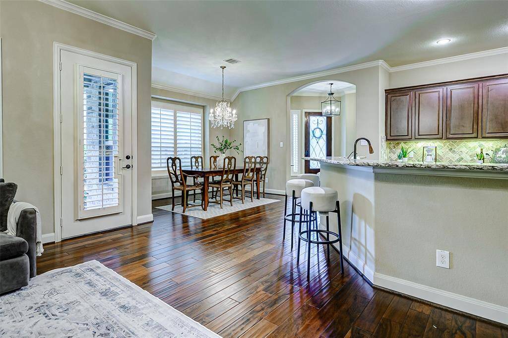 The open-concept layout ensures a seamless flow to the dining room, kitchen, and covered backyard patio, making indoor-outdoor living effortless and enjoyable year-round.