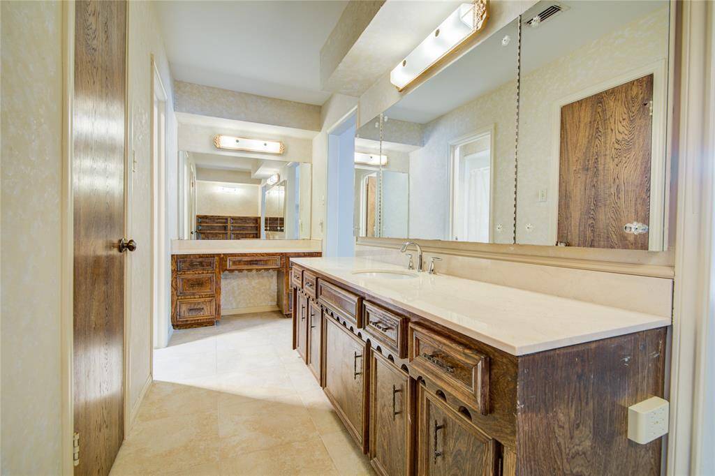 An alternate angle reveals a dedicated sitting vanity area at the opposite end of the ensuite, adding function and flexibility to the space.