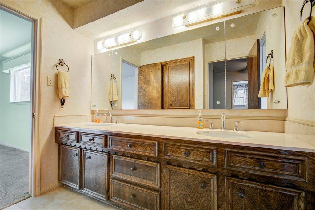 The upstairs secondary bathroom hasdual sinks and is open to abedroom and hallway.