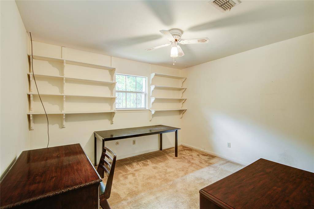 The third secondary bedroom has built in shelving and overlooks the front yard.